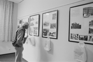 Mann betrachtet Ausstellungstafeln mit historischen Bildern an der Wand